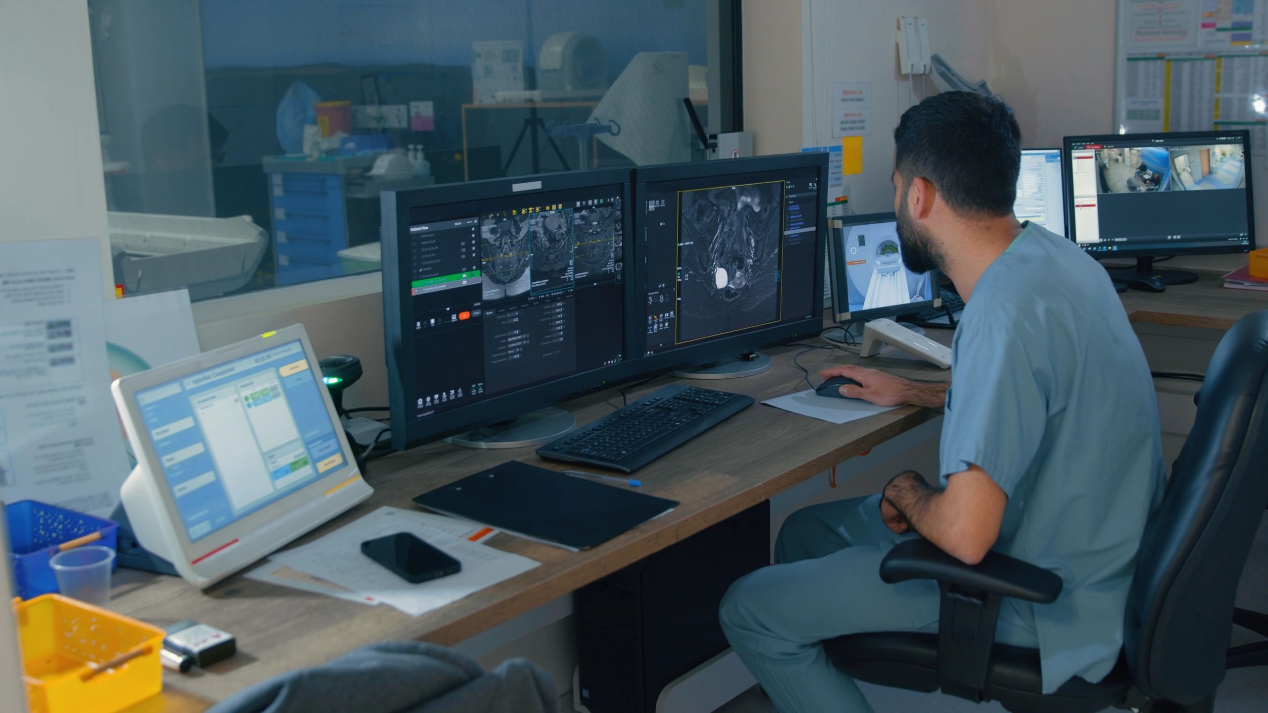 Medical professional reviewing technical imaging and documentation